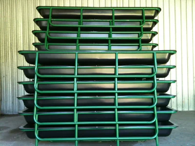 Green steel bunk feeders lined up in the yard