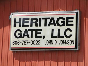 Heritage Gate, LLC sign on a red barn listing the phone number and owner John D. Johnson